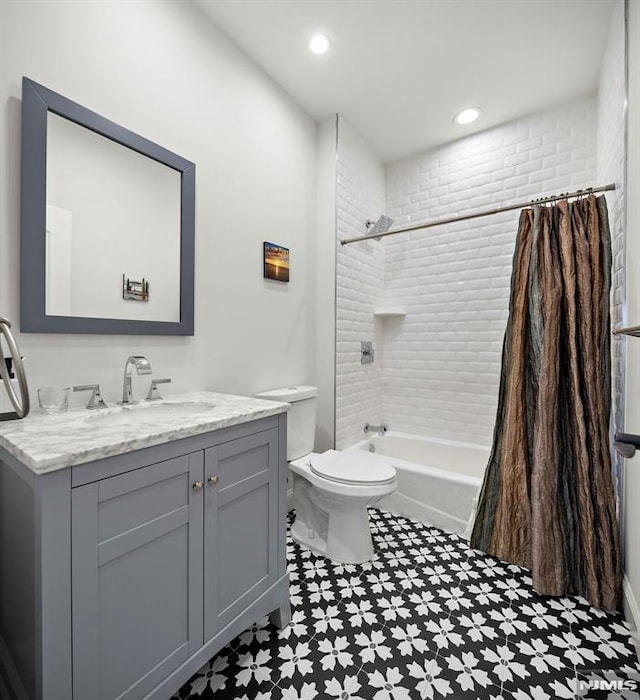 full bathroom featuring shower / tub combo with curtain, vanity, and toilet