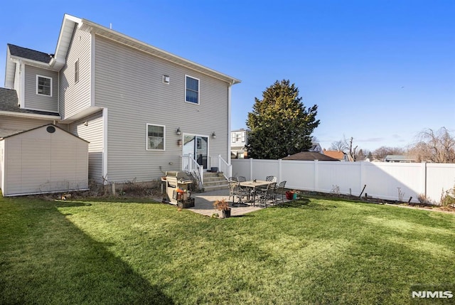 rear view of property with a patio and a yard