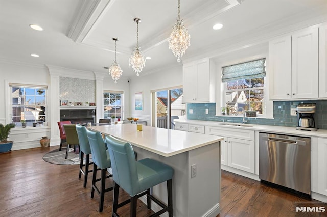 kitchen featuring a kitchen island, white cabinets, dishwasher, and sink