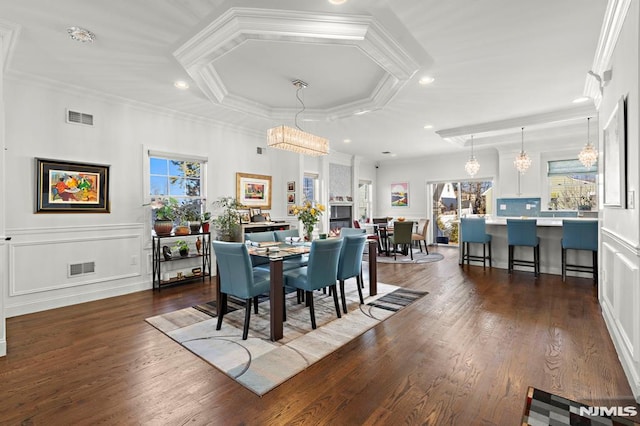 dining area featuring ornamental molding and dark hardwood / wood-style floors