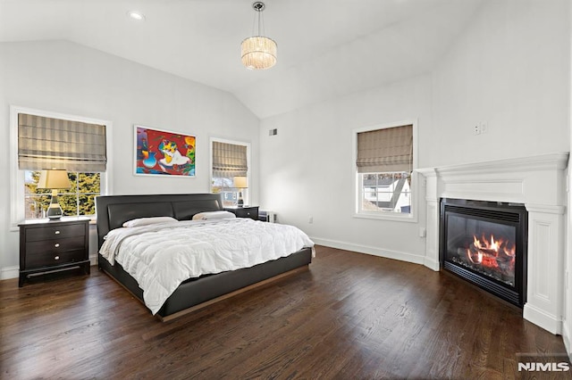 bedroom featuring dark wood-type flooring and lofted ceiling