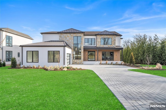 rear view of property featuring a yard