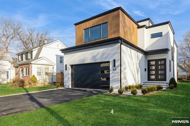 contemporary home featuring a garage and a front yard