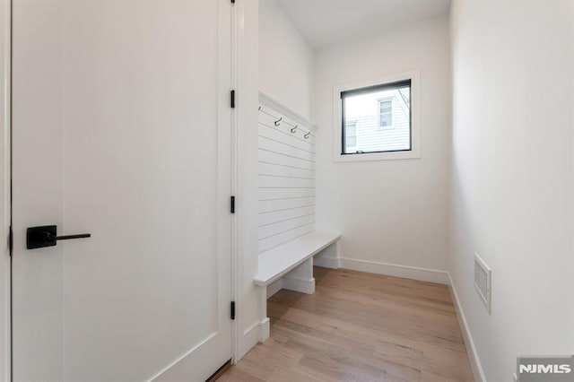 mudroom with light hardwood / wood-style floors