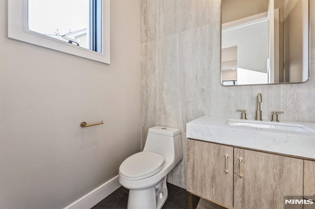 bathroom with toilet and vanity