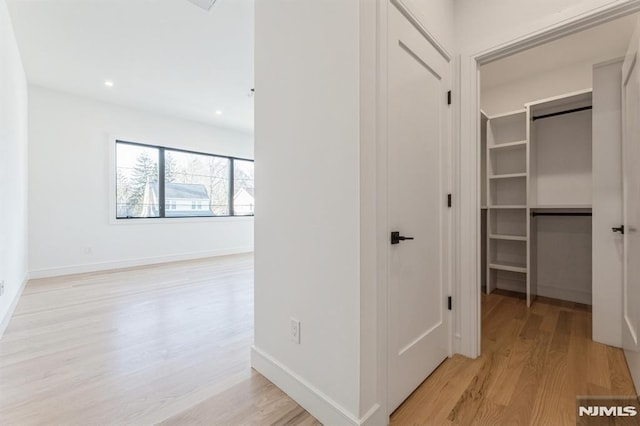 hallway with light wood-type flooring