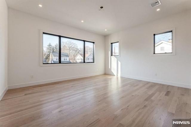 spare room with light hardwood / wood-style flooring