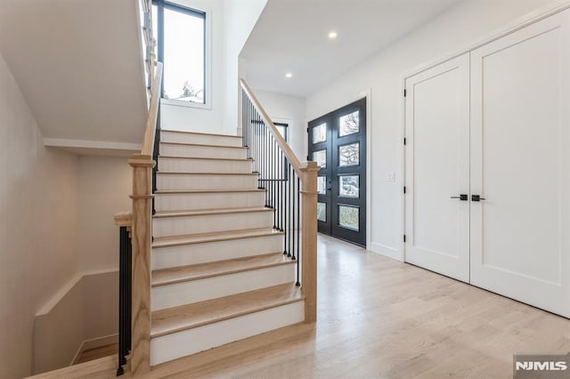 foyer entrance featuring light wood-type flooring and french doors