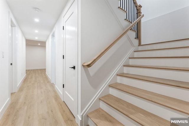 stairway with wood-type flooring