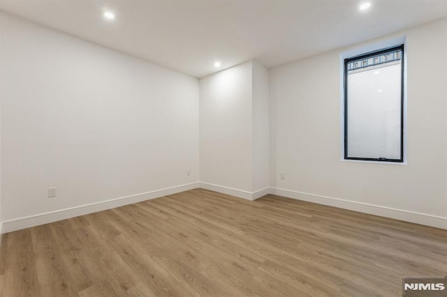 spare room featuring light wood-type flooring