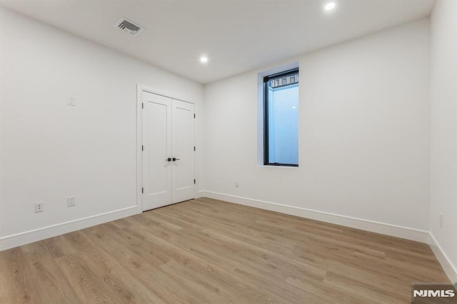 spare room featuring light hardwood / wood-style flooring