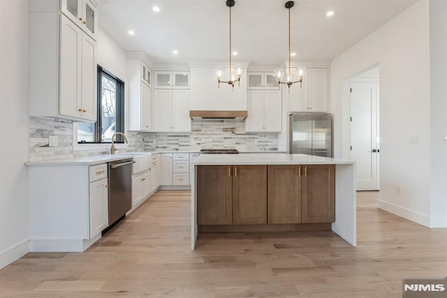 kitchen with white cabinetry, stainless steel appliances, and a kitchen island