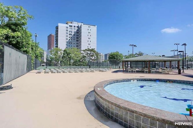 view of swimming pool featuring a gazebo and a patio area