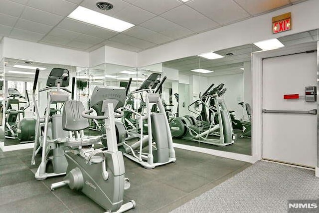 workout area with a paneled ceiling