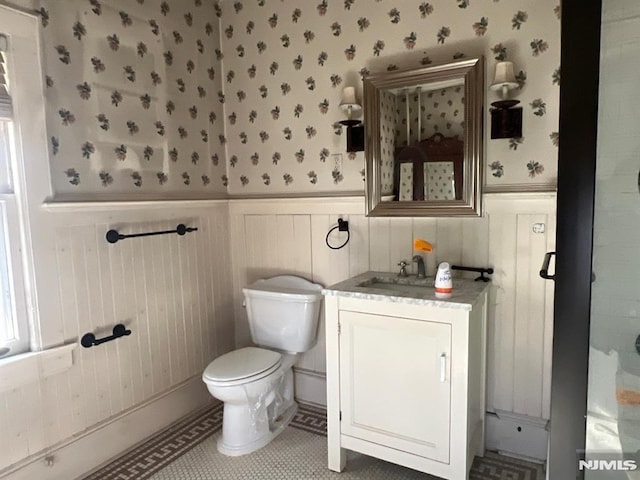 bathroom with tile patterned floors, vanity, and toilet