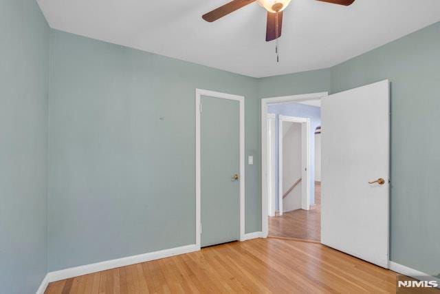 empty room featuring ceiling fan and hardwood / wood-style floors