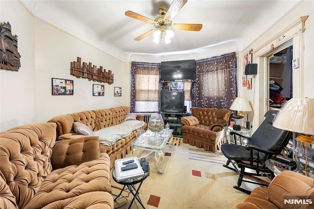 carpeted living room with ceiling fan