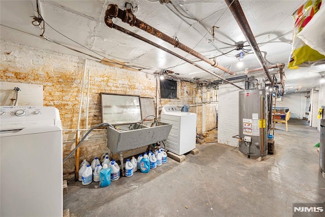 basement featuring washer / dryer, sink, and water heater