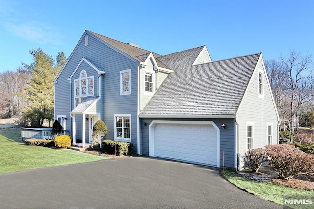 view of front of home featuring a garage and a front lawn