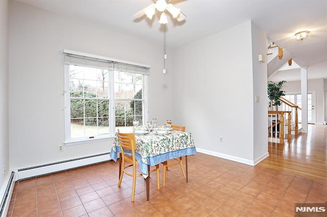 dining space featuring ceiling fan, a baseboard heating unit, and tile patterned floors