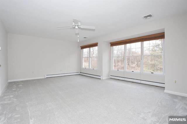 carpeted empty room with ceiling fan and a baseboard radiator