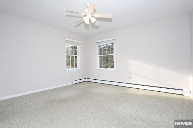 carpeted spare room featuring ceiling fan and baseboard heating