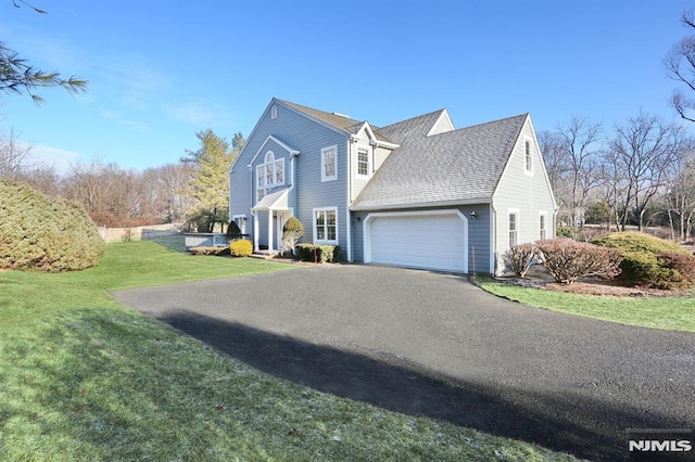 view of property exterior featuring a yard and a garage