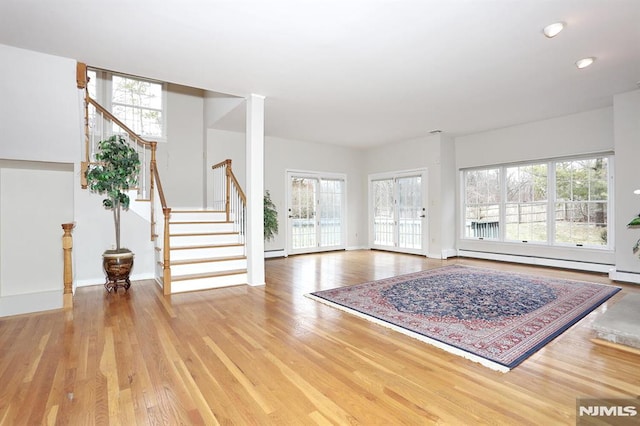 interior space featuring a baseboard radiator and hardwood / wood-style floors