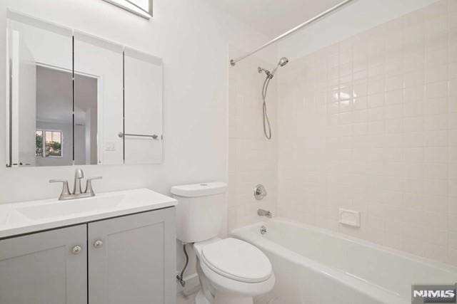 full bathroom featuring vanity, toilet, and tiled shower / bath