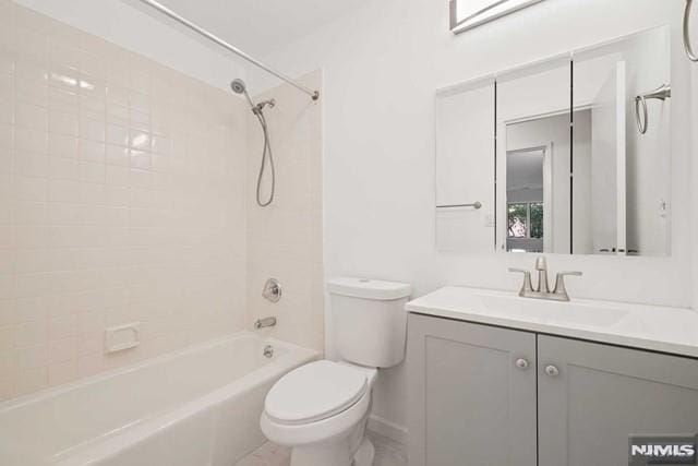 full bathroom featuring vanity, toilet, and tiled shower / bath