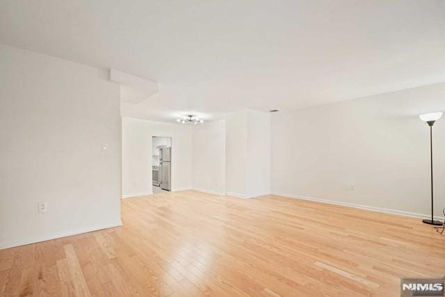 spare room featuring light hardwood / wood-style floors