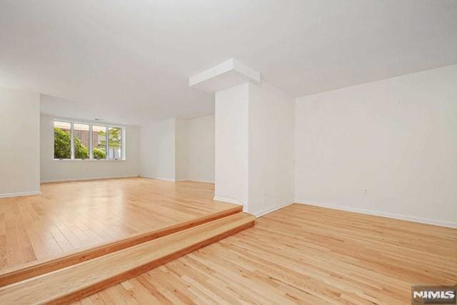 spare room featuring light wood-type flooring