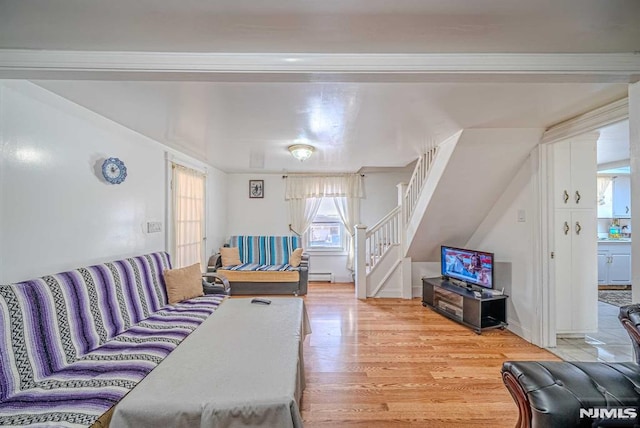 living room with light hardwood / wood-style floors and a baseboard radiator