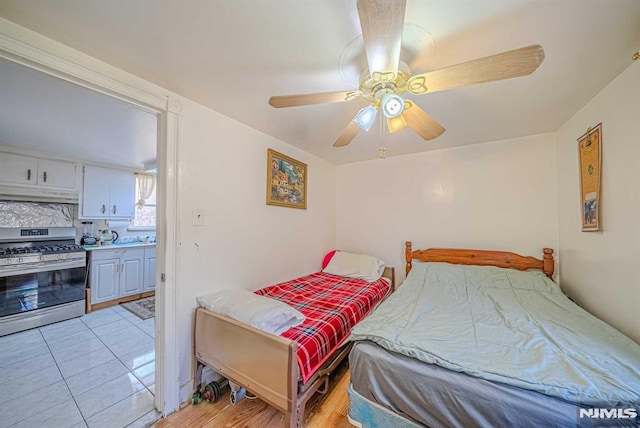 bedroom featuring ceiling fan and light tile patterned floors