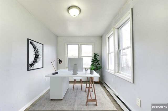 office space featuring a wealth of natural light and a baseboard radiator