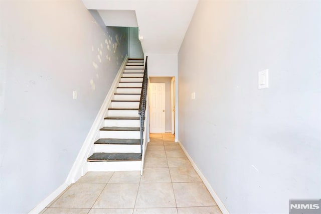 stairs featuring tile patterned flooring