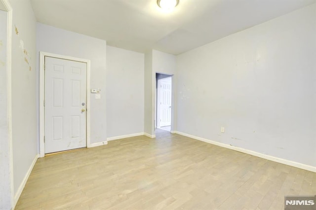 spare room featuring light wood-type flooring