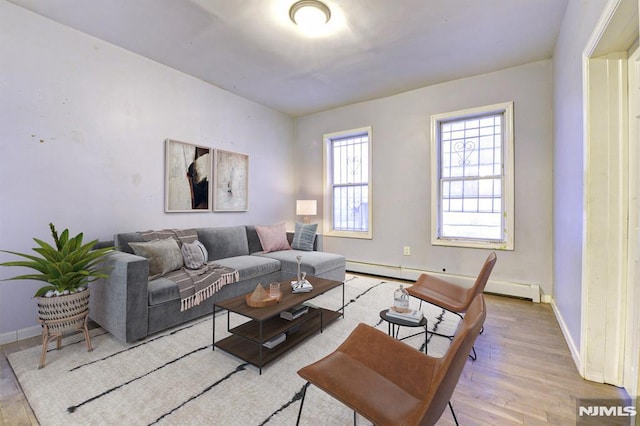 living room with light hardwood / wood-style flooring and a baseboard heating unit