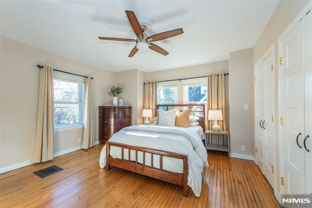 bedroom with light wood-type flooring and ceiling fan