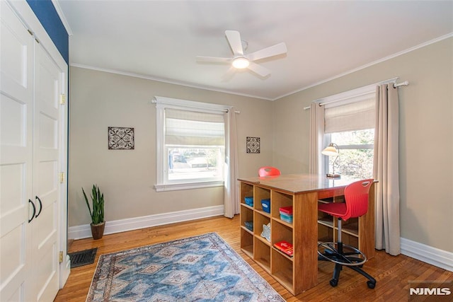 dining space with ceiling fan, wood-type flooring, and ornamental molding