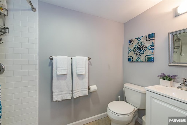 bathroom featuring a shower, vanity, and toilet