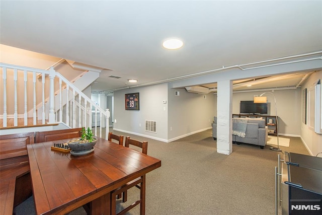 dining space featuring carpet and a wall mounted air conditioner