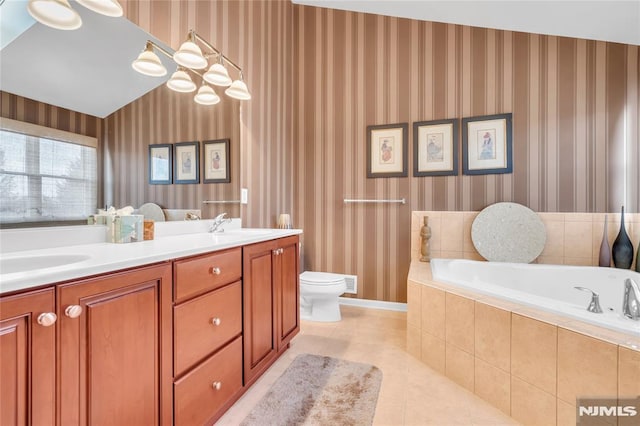 bathroom with toilet, tile patterned flooring, tiled bath, and vanity