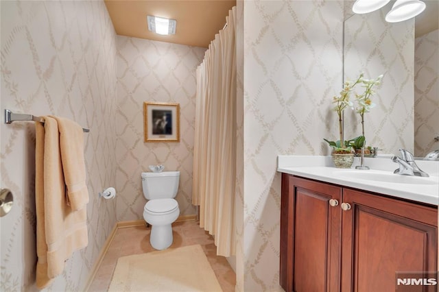 bathroom featuring toilet, tile patterned flooring, and vanity