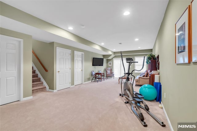 exercise room with light colored carpet