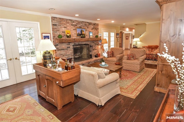 living room featuring french doors, dark hardwood / wood-style flooring, and a brick fireplace