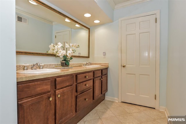 bathroom featuring tile patterned flooring, crown molding, and vanity