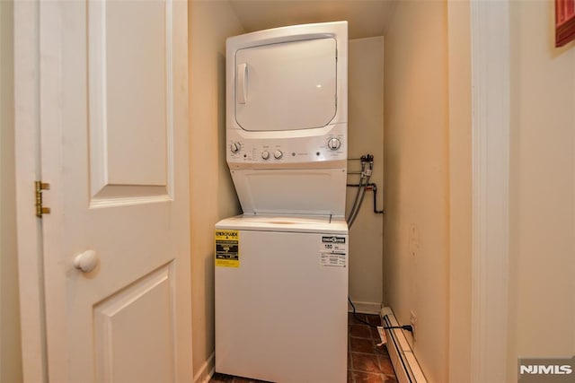 laundry room with stacked washing maching and dryer and a baseboard radiator