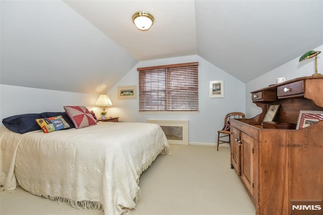 carpeted bedroom featuring lofted ceiling