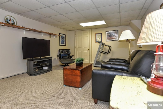 carpeted living room featuring a drop ceiling